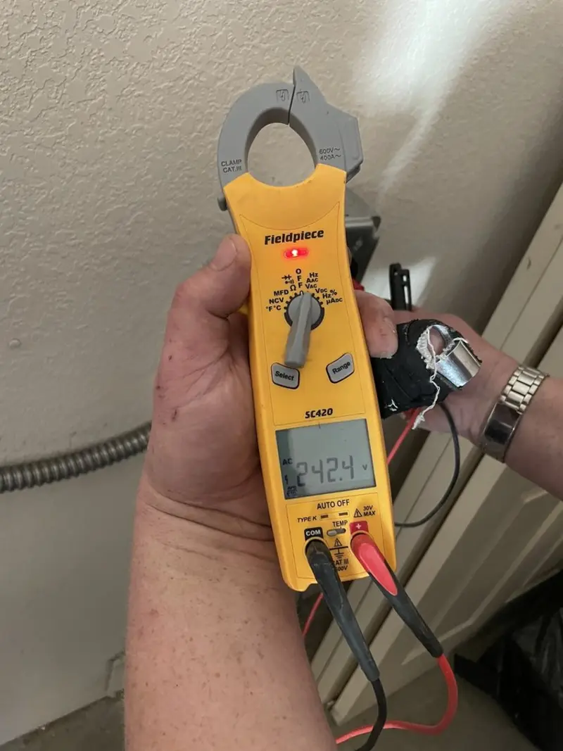 Voltage testing with clamp meter during Whole House Surge Protector in Spencer